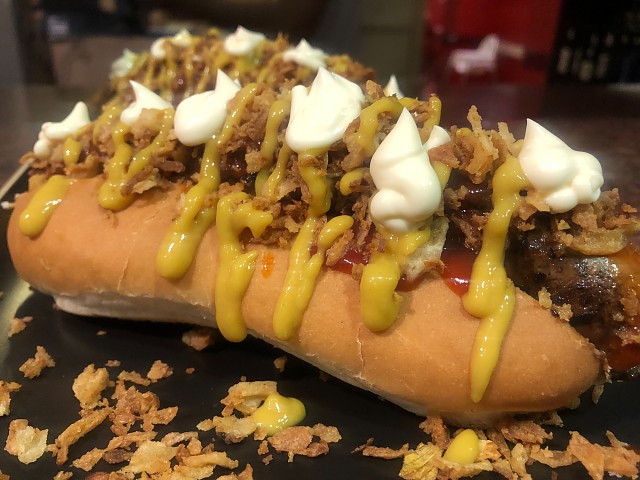 Hot dog valencien avec chorizo ​​de porc XL assaisonné, ketchup à la moutarde douce et oignons frits croustillants